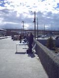 ABQ: flute player with wares for sale